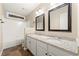 Double vanity bathroom with granite countertop and tile flooring at 7124 Big Woods Dr, Woodstock, GA 30189