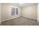 Simple bedroom with carpeted floor and large window at 7124 Big Woods Dr, Woodstock, GA 30189