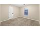 Spacious bedroom with neutral walls and plush carpeting at 7124 Big Woods Dr, Woodstock, GA 30189