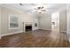 Gathering room with hardwood floors, fireplace and kitchen view at 7124 Big Woods Dr, Woodstock, GA 30189