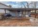 Covered back deck with a grill and outdoor seating; in need of clean up and landscaping at 2545 Kingswood Dr, Marietta, GA 30066