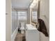 Bright bathroom featuring a white vanity with framed mirror and shower with glass doors at 2545 Kingswood Dr, Marietta, GA 30066