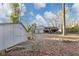 White shed and gray house with deck and stairs in a backyard with leaf covered ground at 2545 Kingswood Dr, Marietta, GA 30066