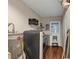 Functional laundry area with washer and dryer, with an access door and storage shelving above at 2545 Kingswood Dr, Marietta, GA 30066