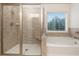 Bathroom with a shower and bathtub, featuring a window at 308 Evening Rain Crst, Canton, GA 30114