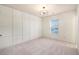 Bright bedroom featuring a wall with board and batten trim and neutral carpeting at 308 Evening Rain Crst, Canton, GA 30114