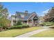 Community clubhouse with a wrap-around porch and manicured lawn at 308 Evening Rain Crst, Canton, GA 30114