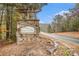 Community entrance sign with landscaping and road at 308 Evening Rain Crst, Canton, GA 30114