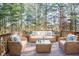 Relaxing deck furnished with wicker seating and tranquil wooded views at 308 Evening Rain Crst, Canton, GA 30114