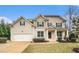 Two-story house with a large front yard and attached garage at 308 Evening Rain Crst, Canton, GA 30114