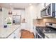 Modern kitchen with white cabinets, granite counters, and stainless steel appliances at 308 Evening Rain Crst, Canton, GA 30114