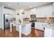 Modern kitchen with white cabinets, granite counters, and stainless steel appliances at 308 Evening Rain Crst, Canton, GA 30114