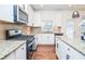 Modern kitchen with white cabinets, granite counters, and stainless steel appliances at 308 Evening Rain Crst, Canton, GA 30114