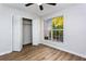 Cozy bedroom with wood-look flooring, ceiling fan, and spacious closet at 557 Summit Sw Ln, Marietta, GA 30008