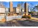 Two-story townhome with brick and siding exterior, white picket fence, and ample parking at 557 Summit Sw Ln, Marietta, GA 30008