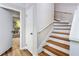 Wooden staircase with white risers and railing at 557 Summit Sw Ln, Marietta, GA 30008