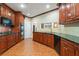 Well-equipped kitchen featuring dark wood cabinets, granite counters, and a double oven at 5300 Brooke Ridge Dr, Atlanta, GA 30338