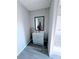 Grey vanity with a mirror in the bathroom at 80 Amberly Way, Carrollton, GA 30116