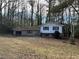 Ranch house with attached garage and mature trees at 905 Nw Magna Carta Dr, Atlanta, GA 30318