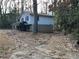 Side view of a ranch home nestled among trees at 905 Nw Magna Carta Dr, Atlanta, GA 30318