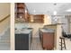 Basement bar with wood cabinets, granite countertop and wine rack at 4301 Horder Ct, Snellville, GA 30039