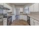 Modern kitchen with white cabinets, black appliances, and granite countertops at 4506 Swan Trce, Atlanta, GA 30349