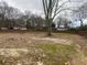 Overgrown lot with a wooden fence in the background at 7163 Swift St, Lithonia, GA 30058