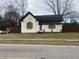 Full view of a fixer-upper house needing renovation, with a fenced yard at 7163 Swift St, Lithonia, GA 30058