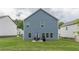 View of backyard with patio, grass, and a partially visible neighboring house at 9061 Jim Purcell Dr, Covington, GA 30014