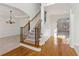 Elegant entryway with hardwood floors, chandelier, and staircase at 3690 Millwater Xing, Dacula, GA 30019