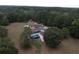 Aerial view showing house, pool, and surrounding land at 4335 Commodore Rd, Powder Springs, GA 30127