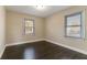 Spacious bedroom with dark hardwood floors and two windows at 1927 Vicki Se Ln, Atlanta, GA 30316