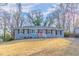 Ranch style home with blue exterior, red door, and landscaped lawn at 1927 Vicki Se Ln, Atlanta, GA 30316