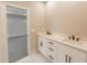 Bathroom with double vanity,white cabinets, and black hardware at 4392 Navajo Se Ln, Acworth, GA 30102