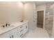 Bathroom with double vanity, white cabinets, and marble shower at 4392 Navajo Se Ln, Acworth, GA 30102