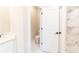 Small half bathroom with toilet and white door at 4392 Navajo Se Ln, Acworth, GA 30102