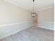 Dining room with chandelier and gray floors at 4392 Navajo Se Ln, Acworth, GA 30102