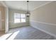 Dining room with chandelier, gray floors, and window at 4392 Navajo Se Ln, Acworth, GA 30102