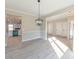 Dining room with chandelier, gray floors, and view of kitchen at 4392 Navajo Se Ln, Acworth, GA 30102