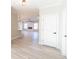 Light and airy entryway with gray floors and white doors at 4392 Navajo Se Ln, Acworth, GA 30102