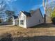 Side view of a white farmhouse with gray roof and large windows at 4392 Navajo Se Ln, Acworth, GA 30102