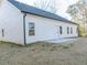 Rear view of house showcasing white siding and patio at 4392 Navajo Se Ln, Acworth, GA 30102