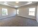 Main bedroom with carpet, tray ceiling, and en-suite bathroom access at 4392 Navajo Se Ln, Acworth, GA 30102