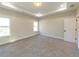 Large main bedroom with plush carpet, tray ceiling, and multiple windows at 4392 Navajo Se Ln, Acworth, GA 30102