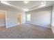 Main bedroom with carpet, tray ceiling, and en-suite bathroom access at 4392 Navajo Se Ln, Acworth, GA 30102