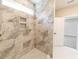 Walk-in shower with marble tile and built-in shelves at 4392 Navajo Se Ln, Acworth, GA 30102