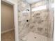 Large walk-in shower with marble tile and window at 4392 Navajo Se Ln, Acworth, GA 30102