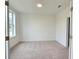 Bright and spacious bedroom with neutral carpeting and large window at 4802 Larkin Pass, Buford, GA 30518