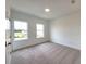 Secondary bedroom with carpet and two windows at 4802 Larkin Pass, Buford, GA 30518