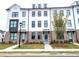 Three-story townhouses with white siding and brick accents at 4802 Larkin Pass, Buford, GA 30518